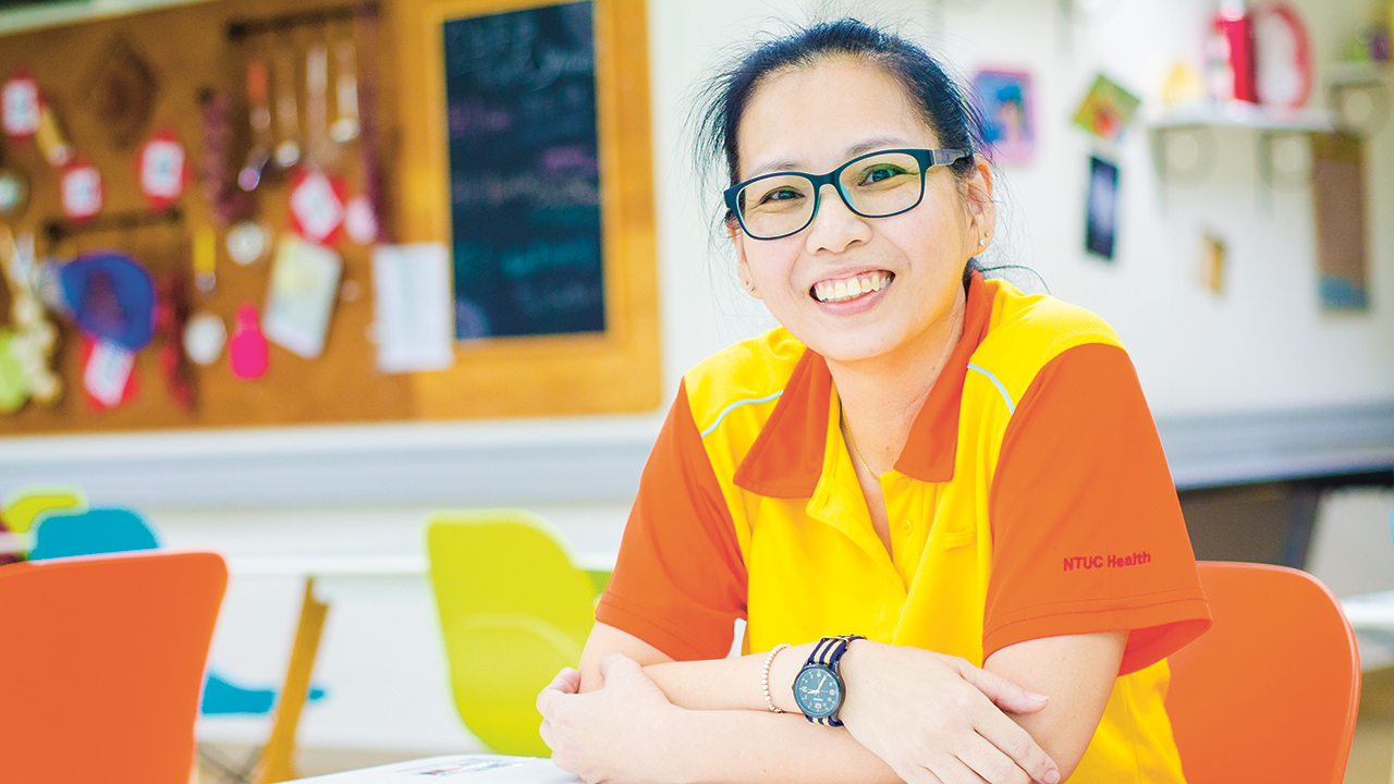 After two months of serious consideration, Sharon took a leap of faith and a 50 per cent pay cut to join the healthcare industry as a therapy assistant with NTUC Health’s Silver Circle. (Photo Source: NTUC This Week)