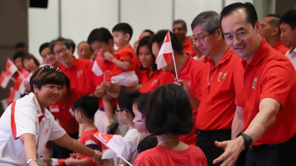 NTUC Deputy Secretary-General Koh Poh Koon welcomes the children to the front of the stage.