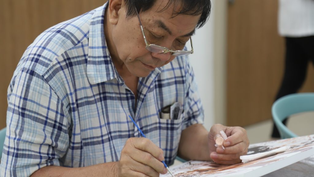 Painting is one of the activities Mr Poo enjoys doing in at the Active Ageing Hub. 