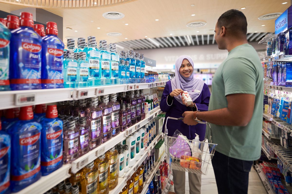 Man and woman in supermarket buying items
