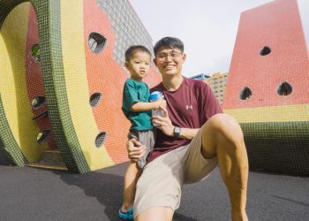 An Asian father and son at a playground in Singapore.