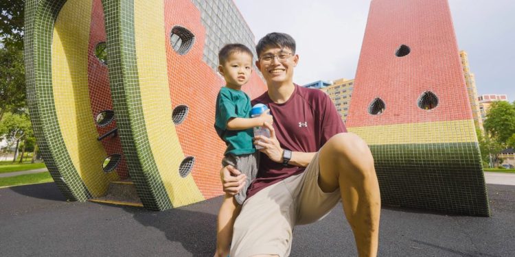 An Asian father and son at a playground in Singapore.