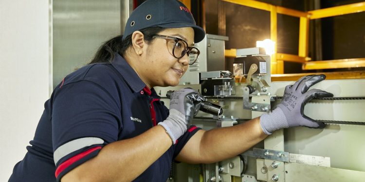 Nur Shafiqah Irwandy, 24, is one of the few female lift specialists at Fujitec, leading a team of technicians and thriving with the support of the Progressive Wage Model.