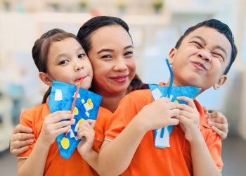 Aishah Mahzan with her children Hizsyafiyah and Hisziqri displaying their artwork from Bright Horizons Fund art classes at My First Skool