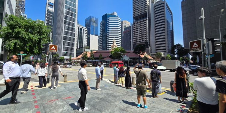 Workers in Singapore’s central business district; real wages grew 4 per cent in 2025 according to MOM’s Report on Wage Practices 2025.